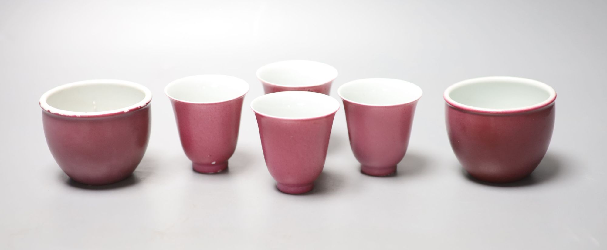 Four Chinese ruby ground cups, and a similar pair of cups, height 6cm